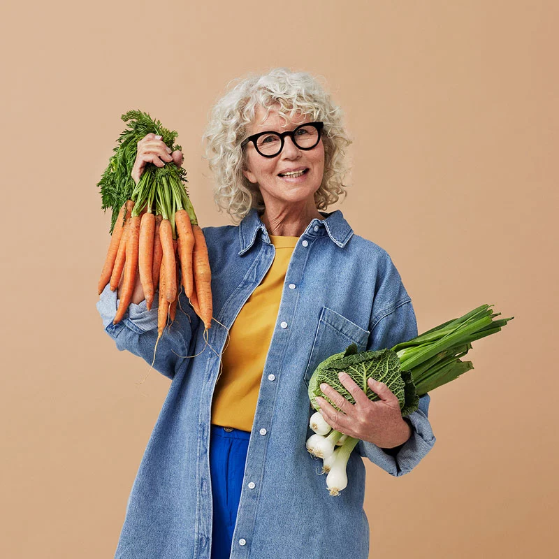 Woman holding vegetables